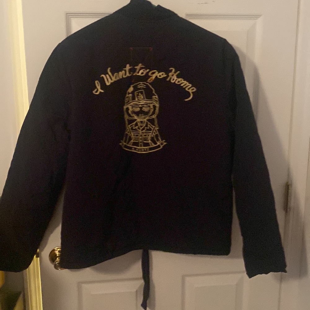 A. Kurtz boys black jacket. Size L. Outer is nylon. Inner is blanket like.